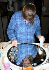 M. Sothderden working on a stained glass border to a mirror